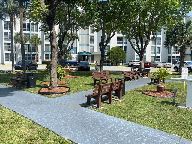 a view of a house with swimming pool and sitting area