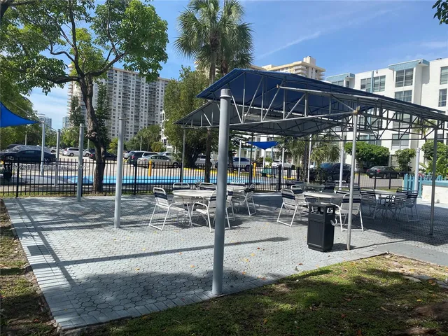 a view of a patio with table and chairs potted plants