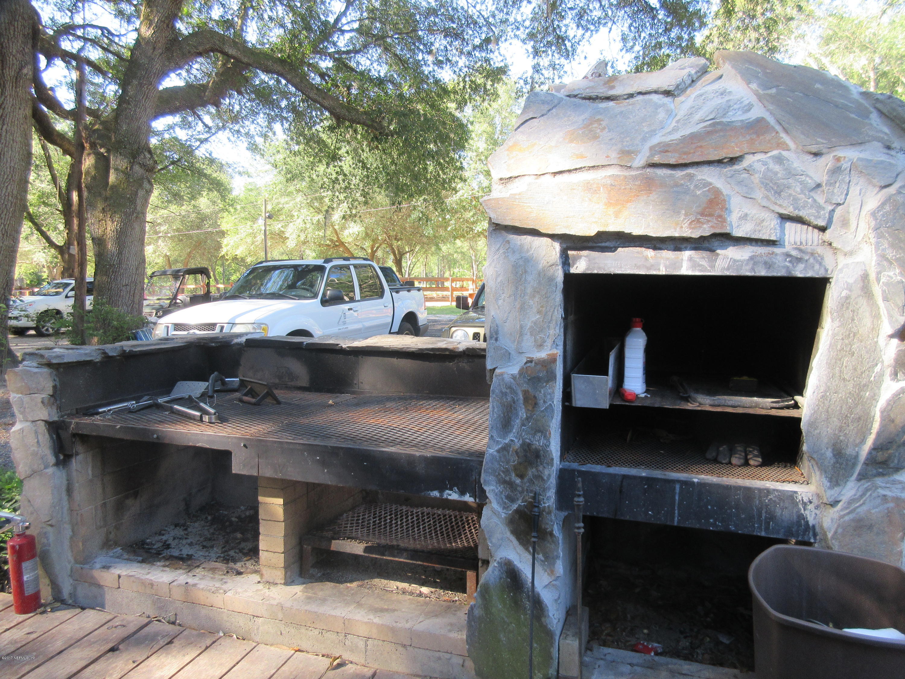 5824 Jones Creek Road Keystone Heights, FL 32656 - Photo 13 of 19 a view of backyard with fireplace and outdoor seating