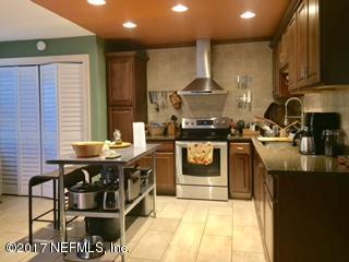 5824 Jones Creek Road Keystone Heights, FL 32656 - Photo 3 of 19 a kitchen with stainless steel appliances granite countertop a stove a sink and a microwave