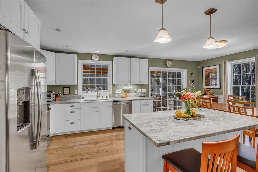 862 Reservoir Road Lunenburg, MA 01462 - Photo 17 of 37 a kitchen with stainless steel appliances granite countertop a stove refrigerator and cabinets