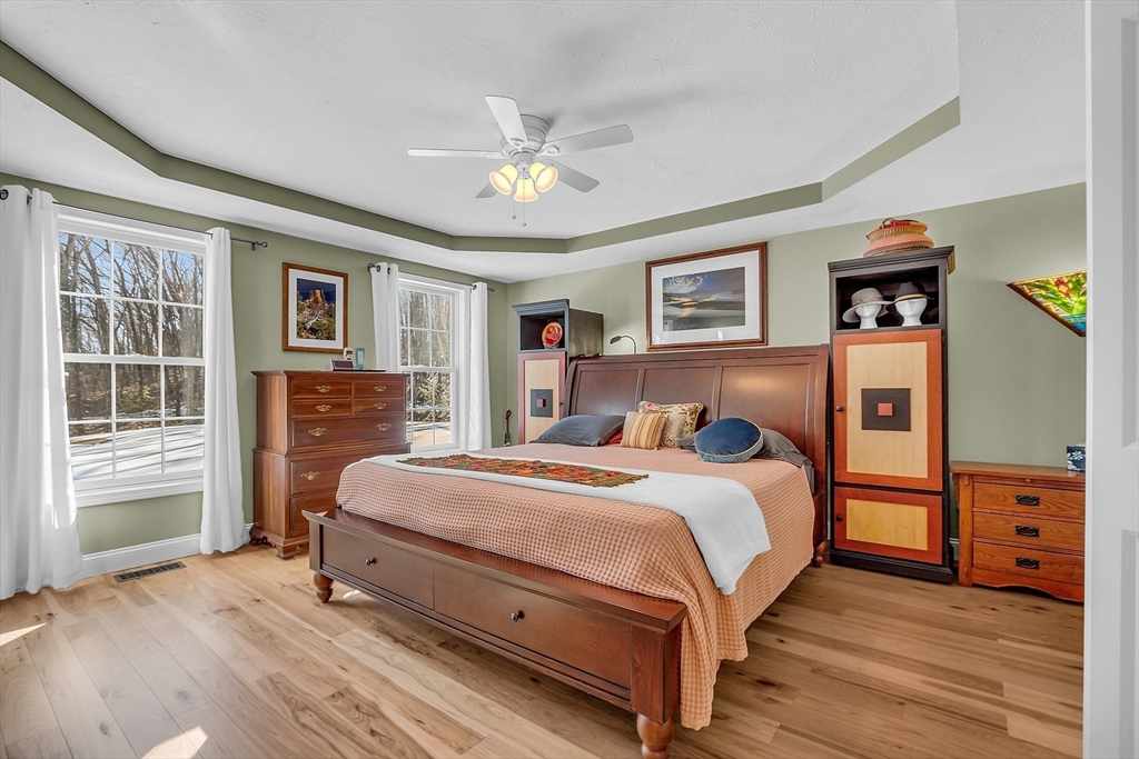 862 Reservoir Road Lunenburg, MA 01462 - Photo 20 of 37 a bedroom with a bed and wooden floor