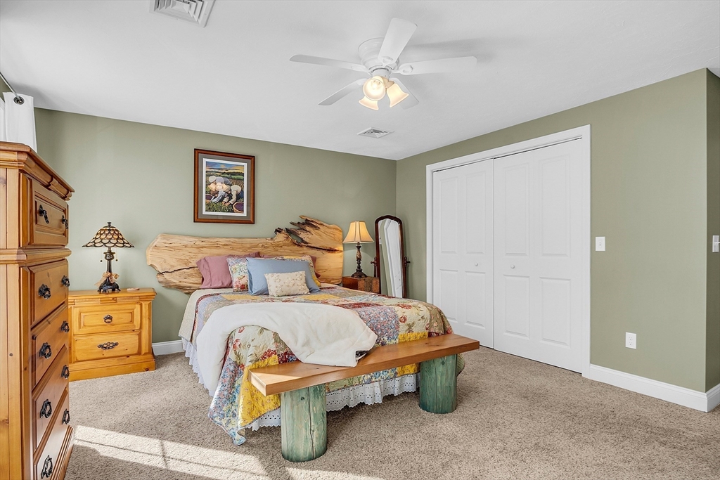 862 Reservoir Road Lunenburg, MA 01462 - Photo 25 of 37 a bedroom with a bed and a chandelier
