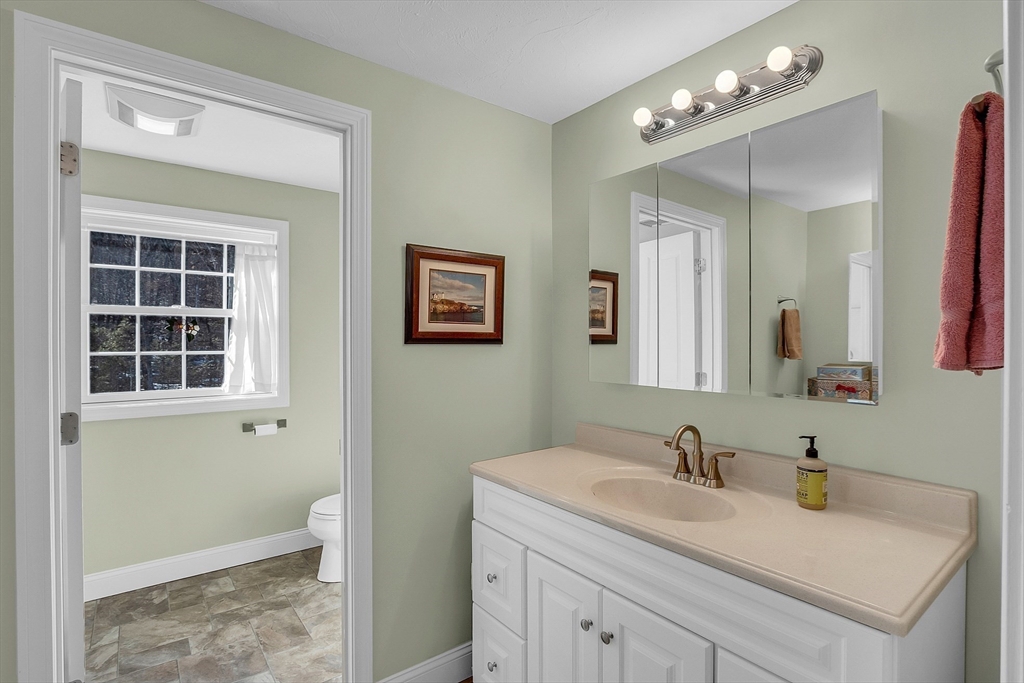 862 Reservoir Road Lunenburg, MA 01462 - Photo 28 of 37 a bathroom with a sink vanity and a mirror