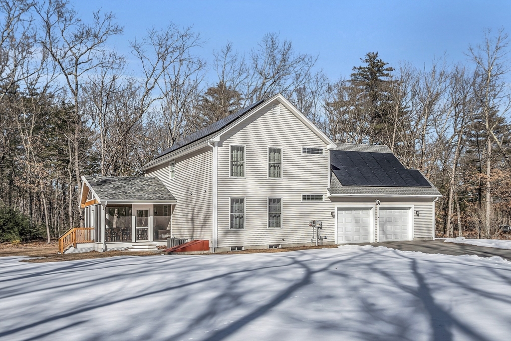 862 Reservoir Road Lunenburg, MA 01462 - Photo 5 of 37 a view of a house with a yard and large trees
