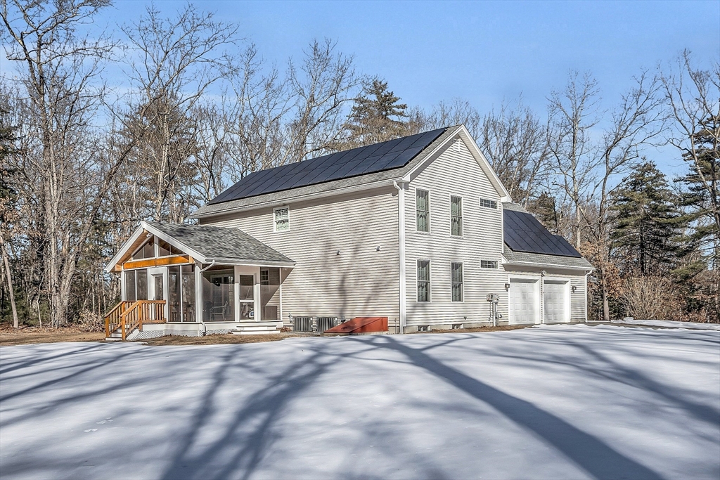 862 Reservoir Road Lunenburg, MA 01462 - Photo 6 of 37 a view of a white house with a large space and a road
