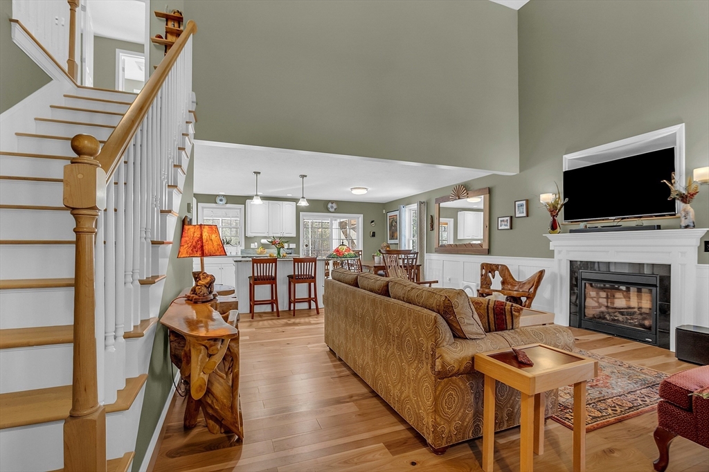 862 Reservoir Road Lunenburg, MA 01462 - Photo 9 of 37 a living room with furniture a fireplace and a flat screen tv