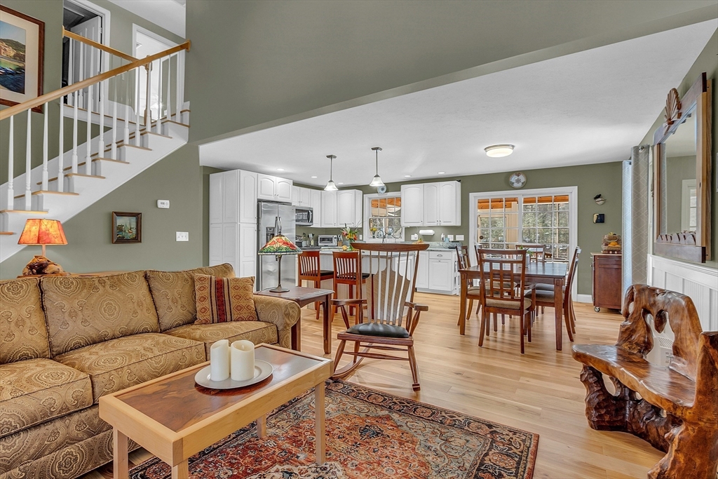 862 Reservoir Road Lunenburg, MA 01462 - Photo 10 of 37 a living room with furniture kitchen view and a wooden floor