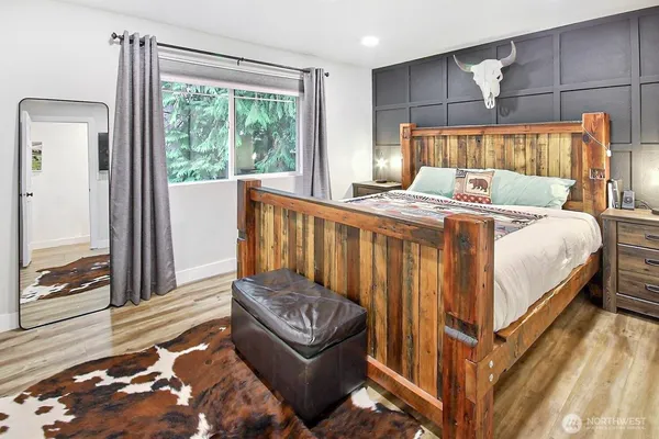 a bed sitting in a bedroom next to a window