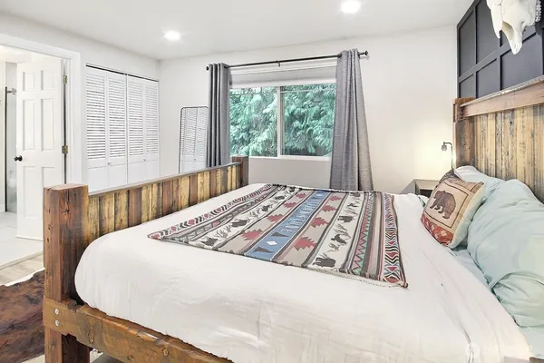 a bedroom with a large bed and a large window