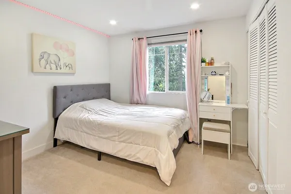 a bedroom with a bed and a painting on the wall