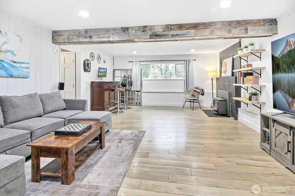 a living room with furniture and a wooden floor