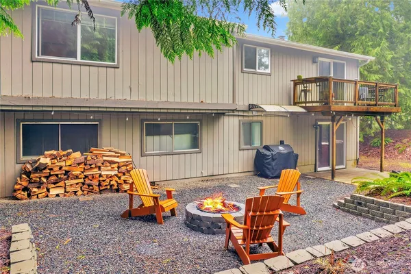 a backyard of a house with outdoor seating