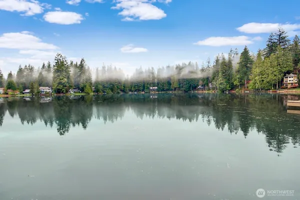 a view of a lake with houses in the back