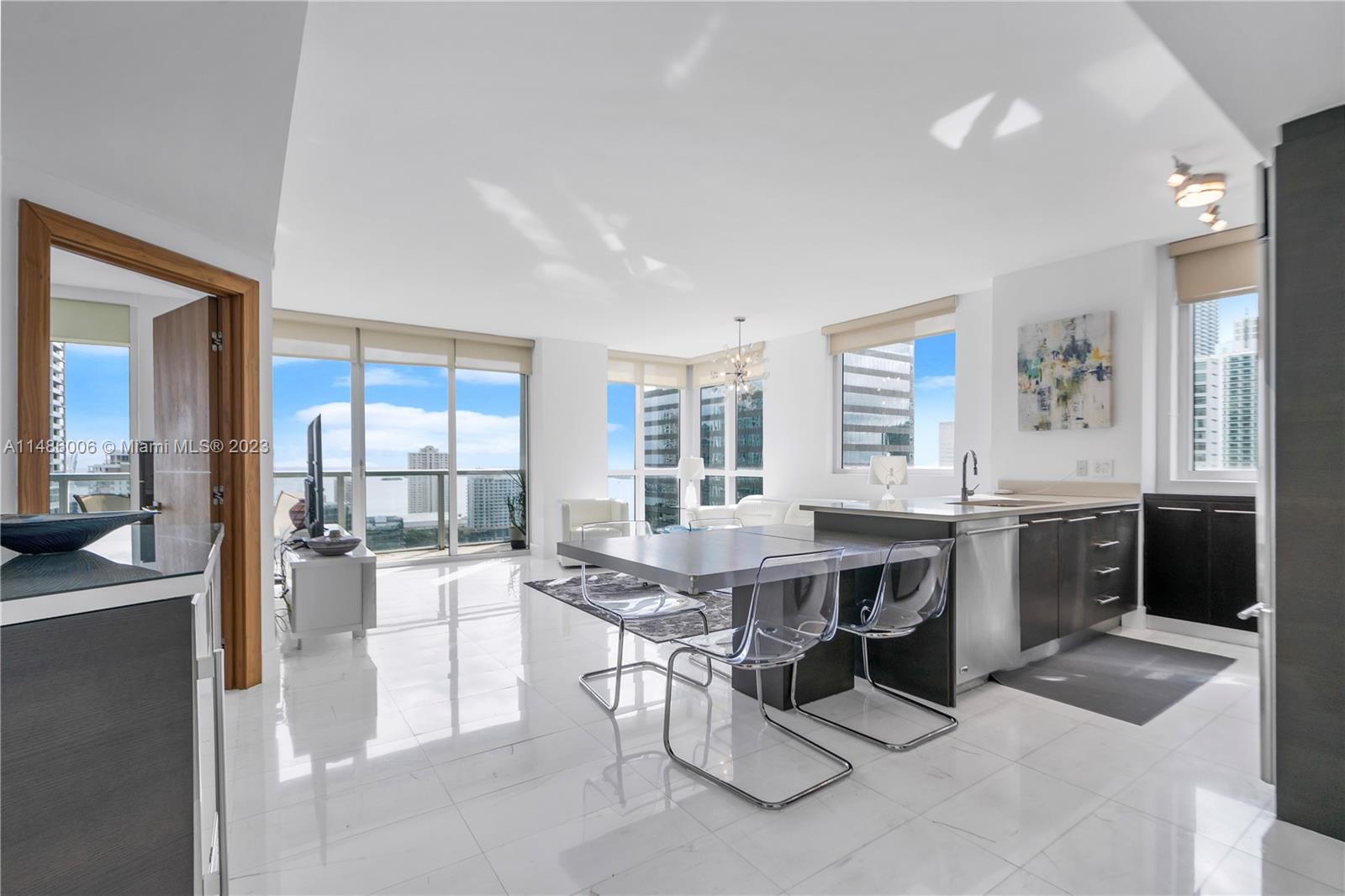 a view of a kitchen with kitchen island granite countertop lots of counter top space and stainless steel appliances