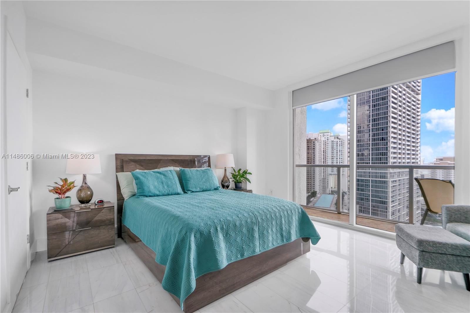 500 Brickell Avenue, Unit 2602 Miami, FL 33131 - Photo 13 of 38 a bedroom with a large bed and a balcony
