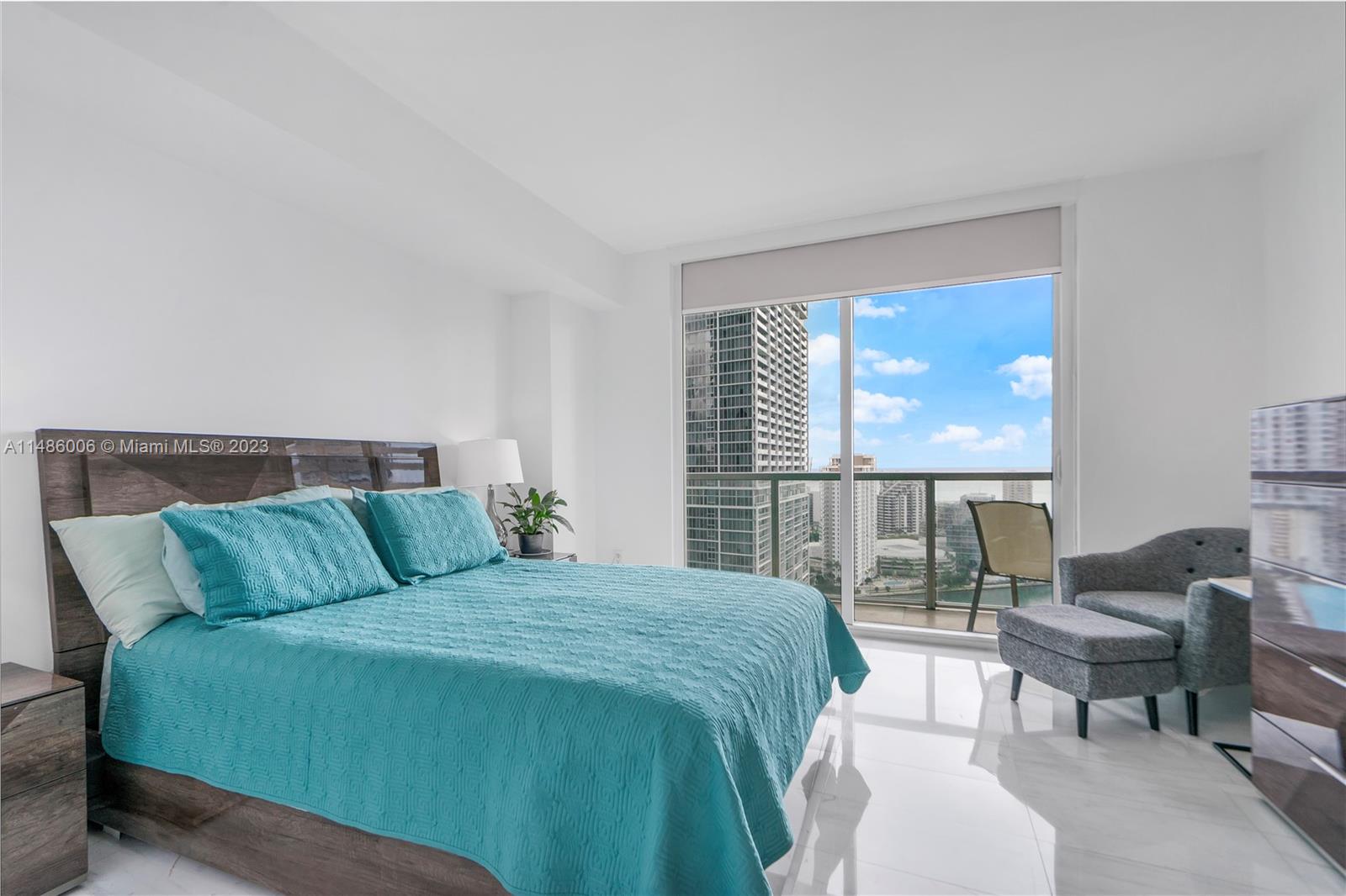 500 Brickell Avenue, Unit 2602 Miami, FL 33131 - Photo 14 of 38 a bedroom with a bed and a couch