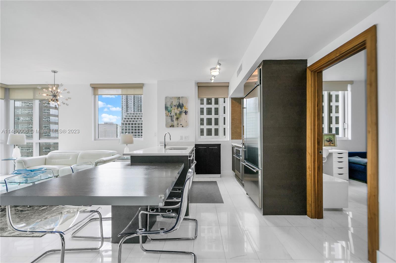 500 Brickell Avenue, Unit 2602 Miami, FL 33131 - Photo 17 of 38 a dining room with furniture and wooden floor