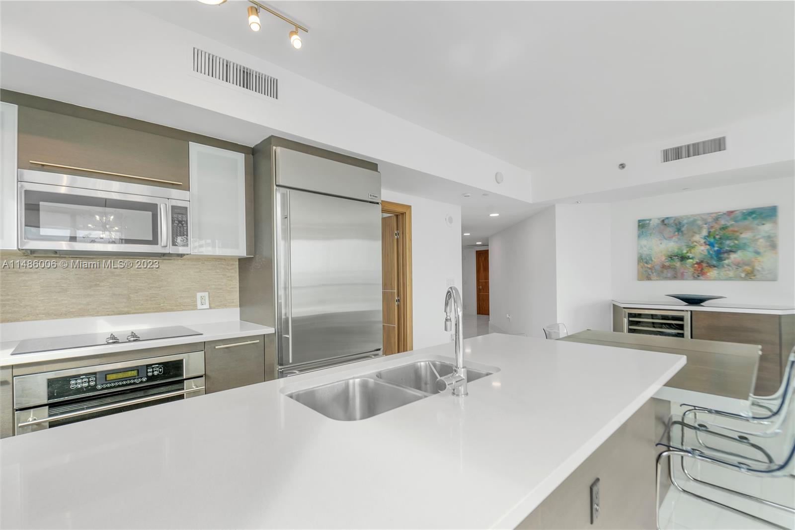 500 Brickell Avenue, Unit 2602 Miami, FL 33131 - Photo 18 of 38 a kitchen with stainless steel appliances granite countertop a sink and a refrigerator