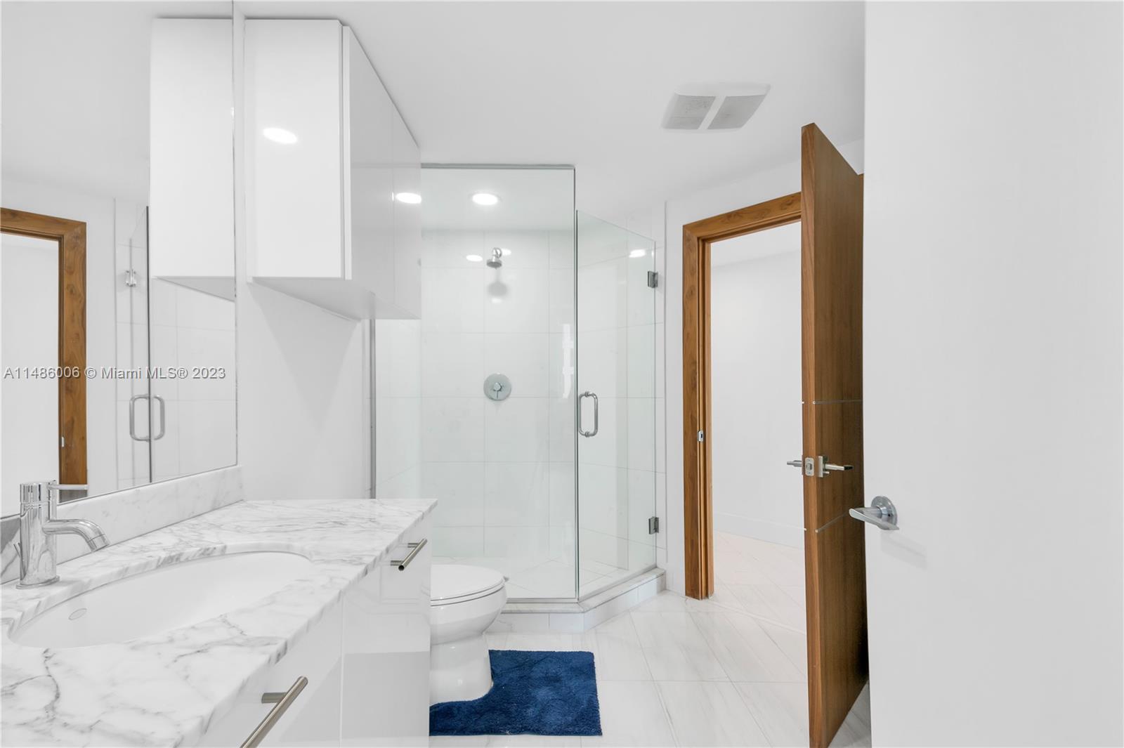 500 Brickell Avenue, Unit 2602 Miami, FL 33131 - Photo 22 of 38 a bathroom with a granite countertop sink a toilet and shower