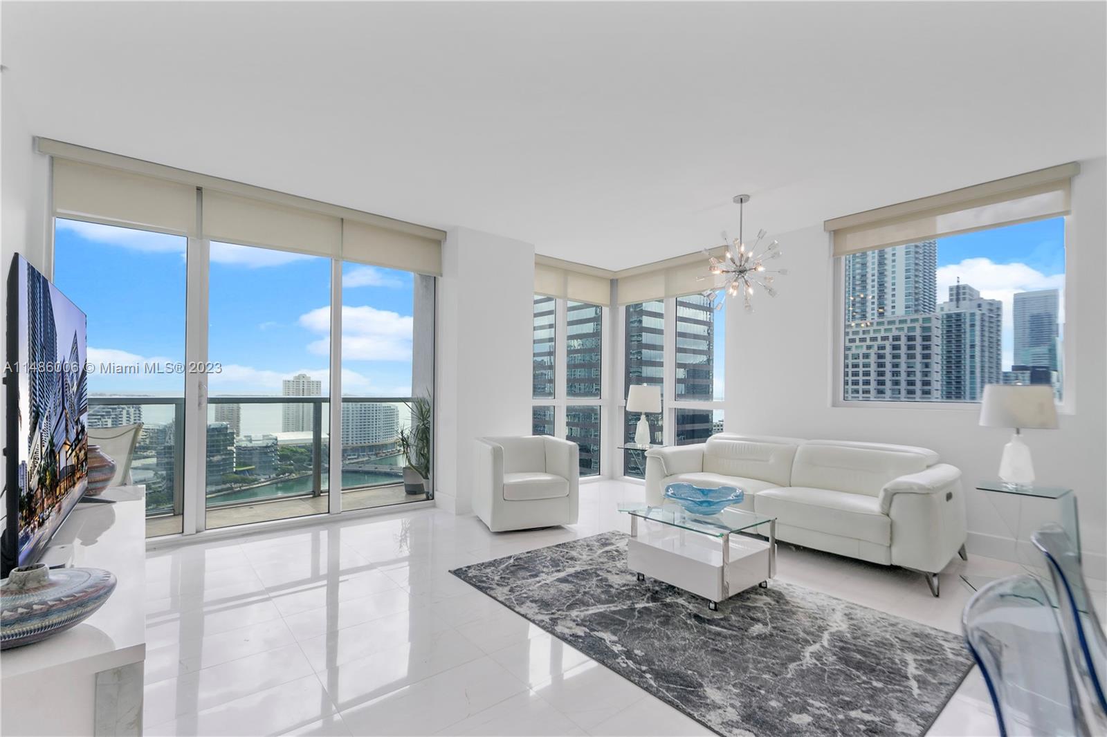 500 Brickell Avenue, Unit 2602 Miami, FL 33131 - Photo 6 of 38 a living room with furniture and a flat screen tv