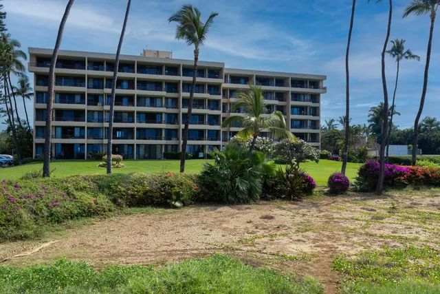 a view of a building with street sign and a lawn chairs