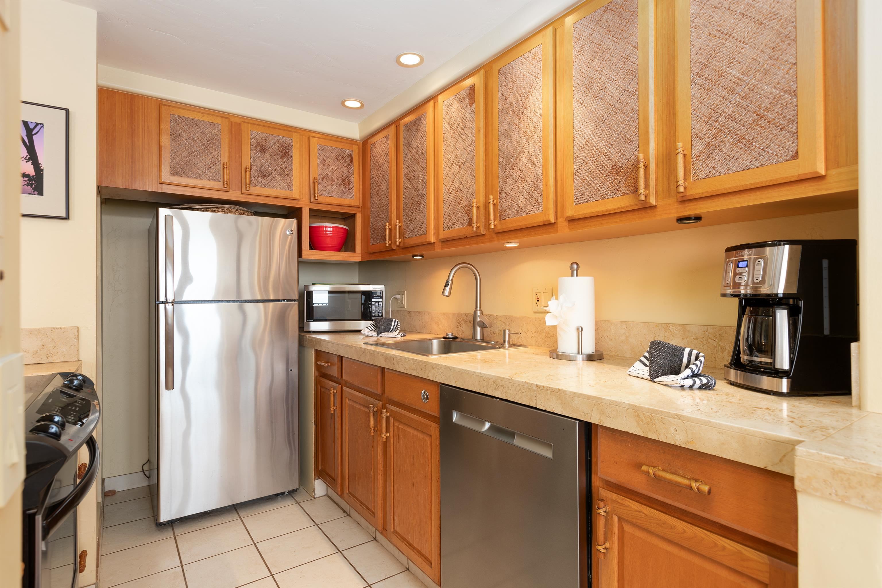 800 South Kihei Road, Unit 302 Kihei, HI 96753 - Photo 5 of 50 a kitchen with stainless steel appliances granite countertop a refrigerator and a sink