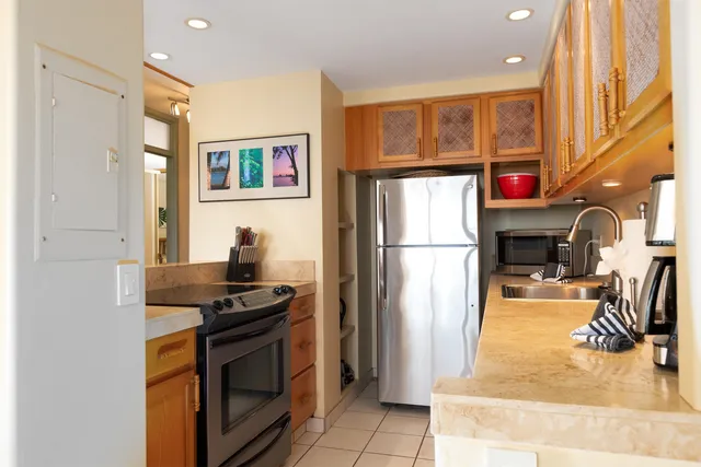 a kitchen with stainless steel appliances granite countertop a sink a stove and a microwave