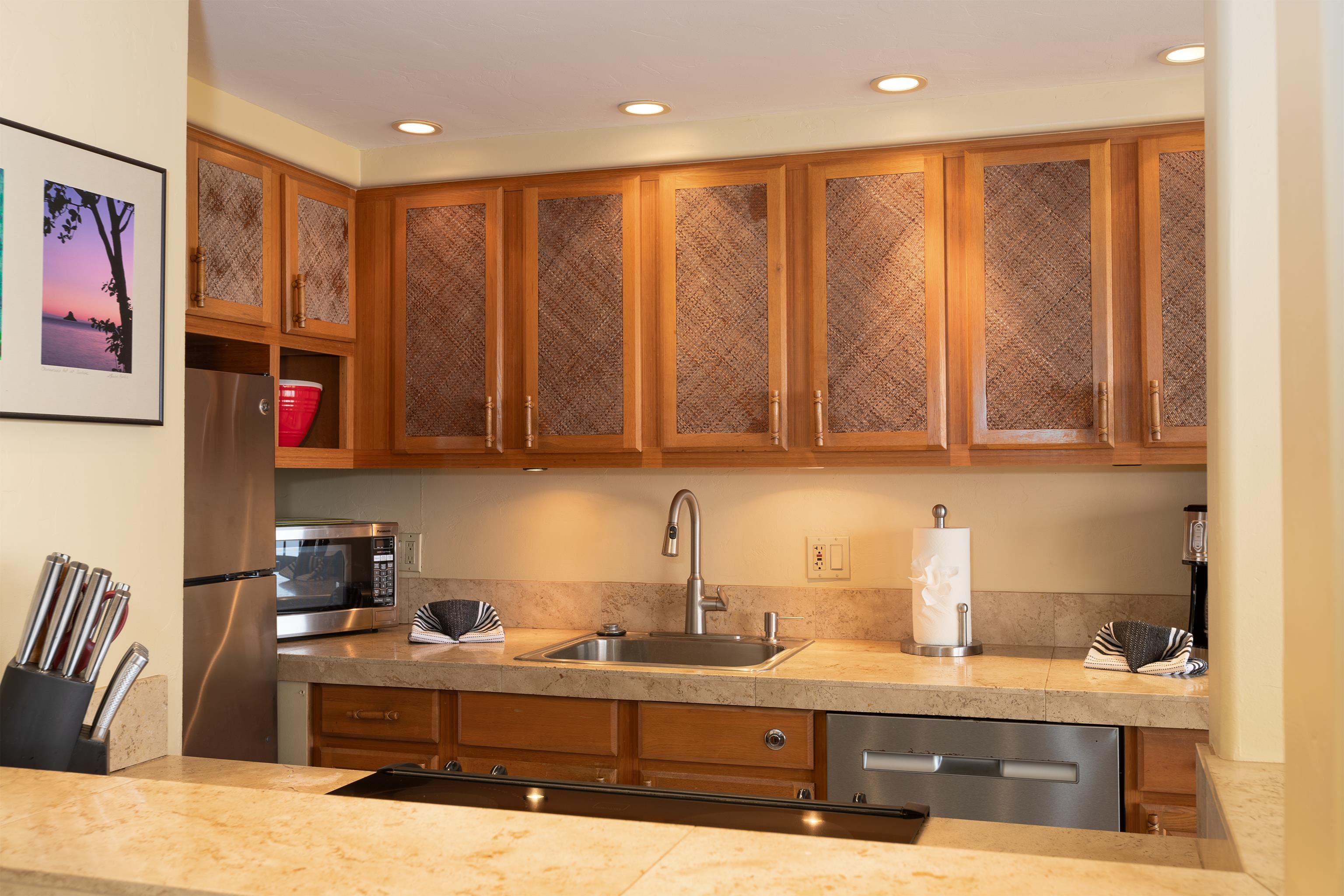 800 South Kihei Road, Unit 302 Kihei, HI 96753 - Photo 7 of 50 a kitchen with stainless steel appliances granite countertop a sink a stove and a microwave