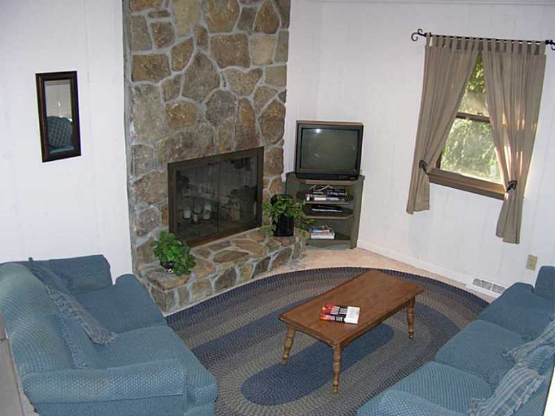 69 Salt Pond Way Westerly, RI 02891 - Photo 2 of 24 Living Room. The living room has a full height stone fireplace.