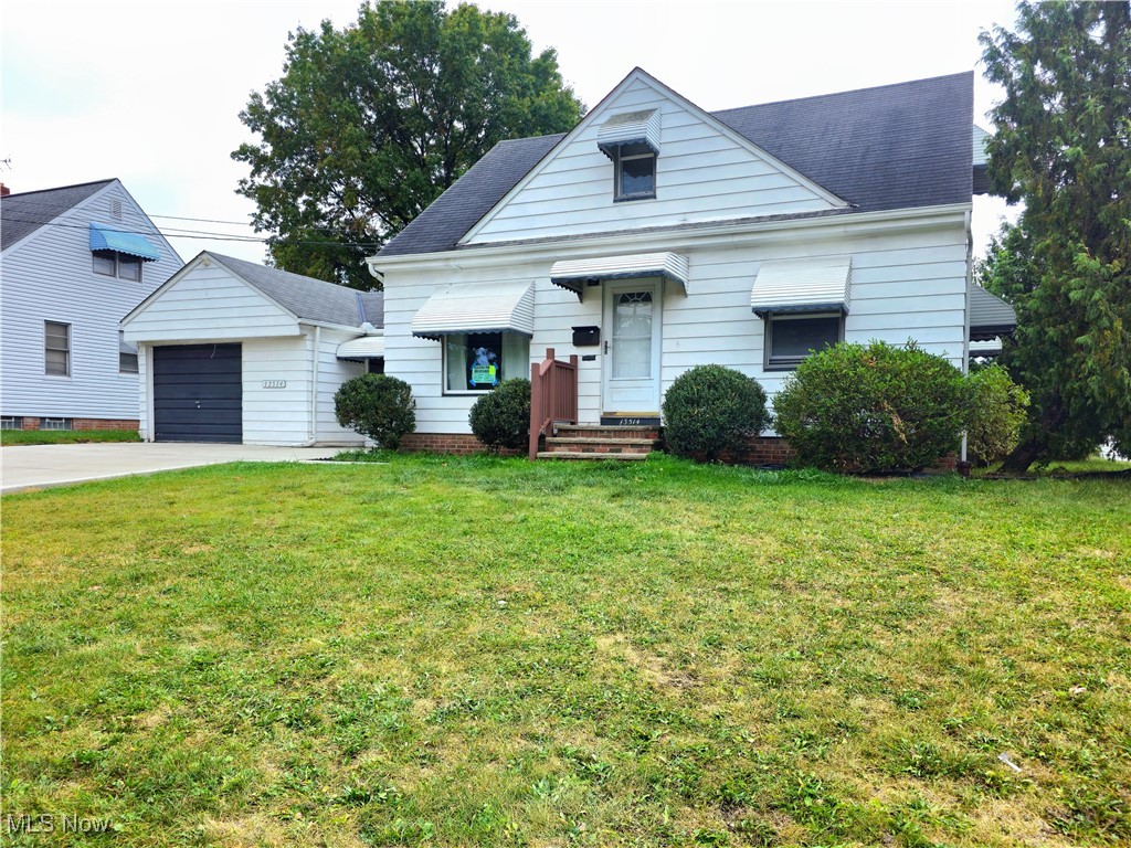 13514 Granger Road Cleveland, OH 44125 - Photo 1 of 23 View of front of home with a garage and a front lawn