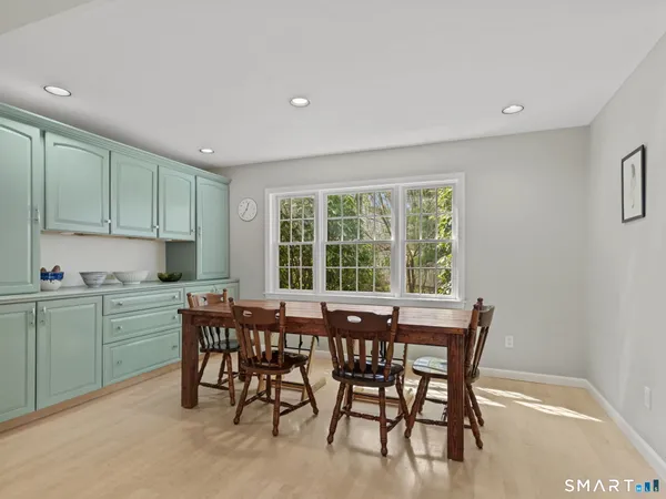 a view of a dining room with furniture and a window