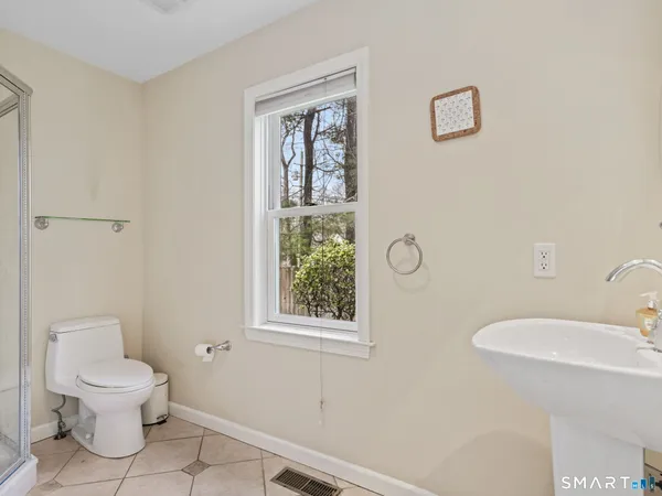 a white toilet sitting next to a bathroom sink