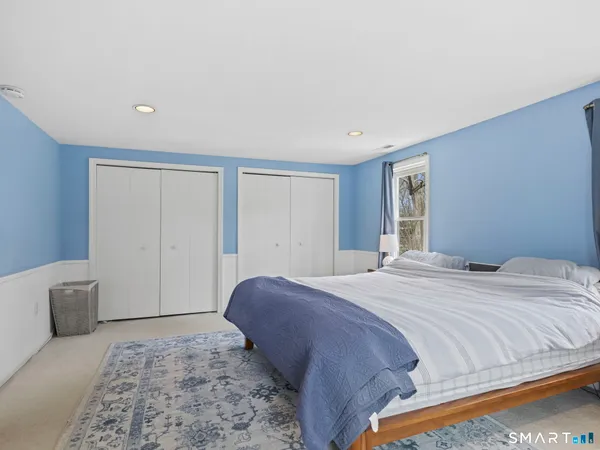 a bedroom with a large bed and a window