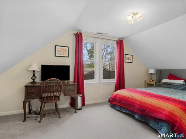 a bedroom with a bed and a chair