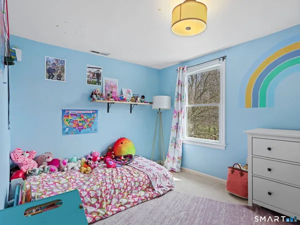 a bed room with a bed and a window