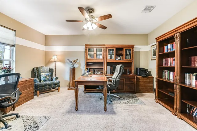 a view of a workspace with furniture and cabinet