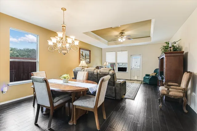 a view of a dining room with furniture wooden floor and chandelier
