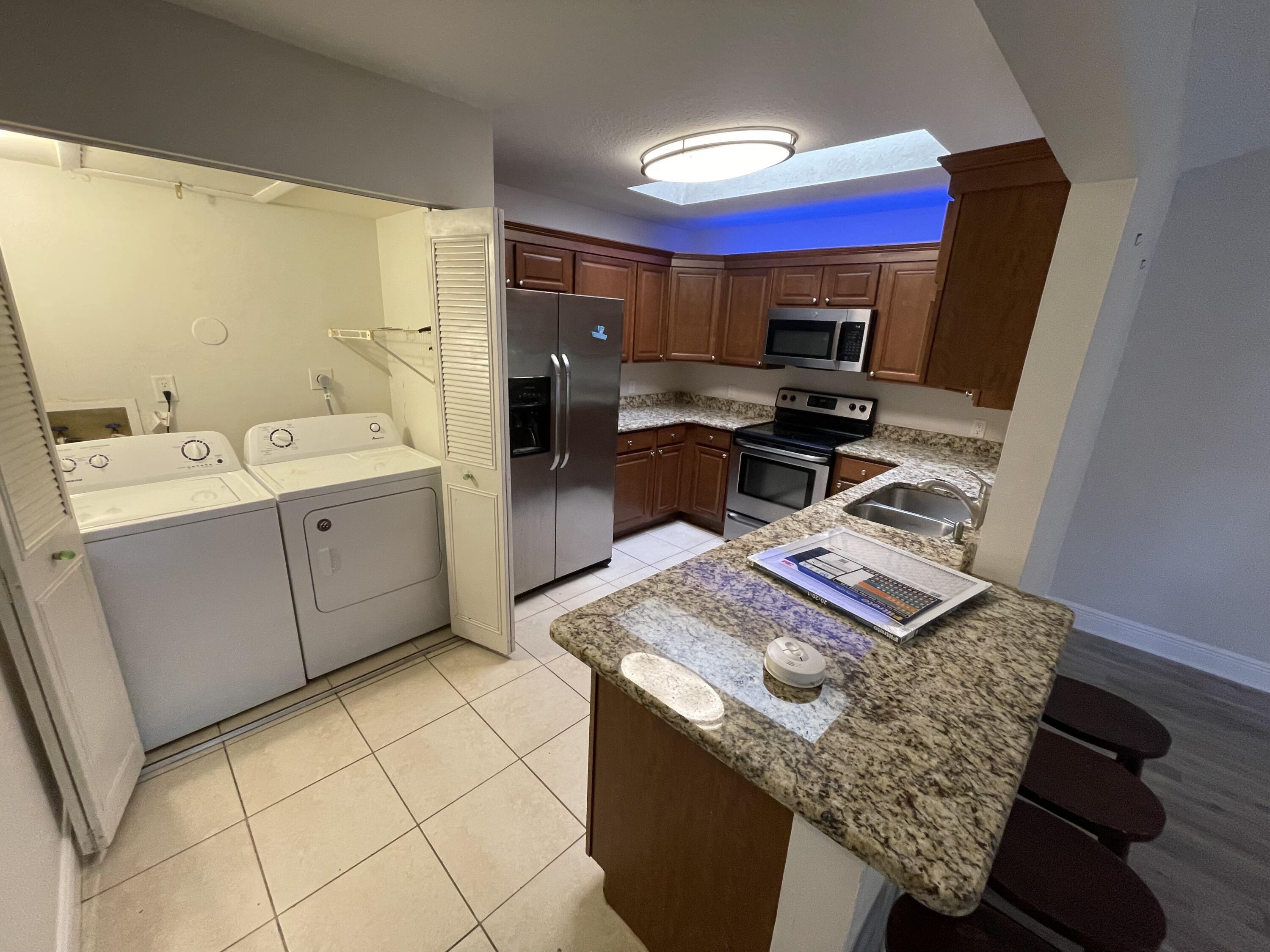 9073 Southeast Hobe Ridge Avenue Hobe Sound, FL 33455 - Photo 2 of 10 9073 Hobe Ridge kitchen laundry