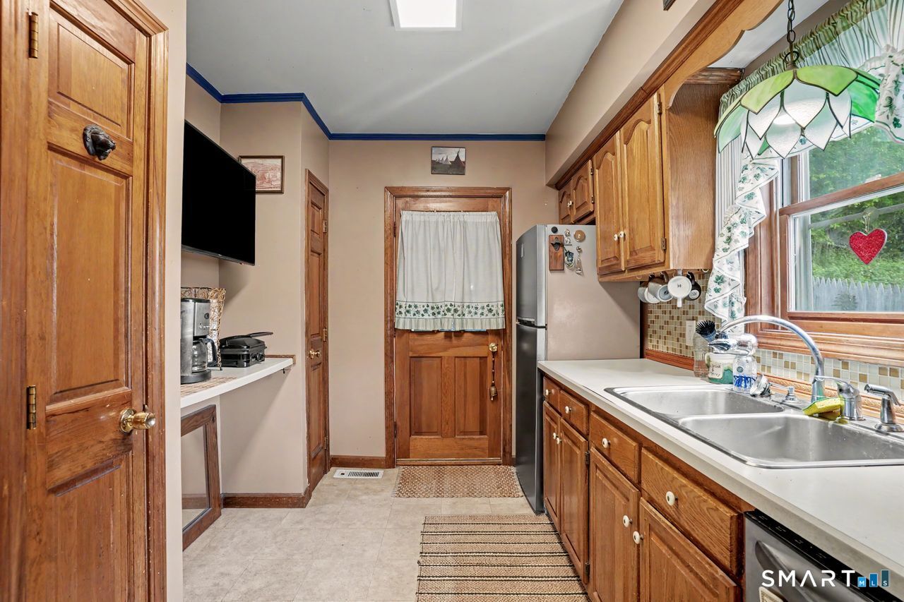 74 Maple Street Seymour, CT 06483 - Photo 9 of 40 a kitchen with a sink stove and refrigerator