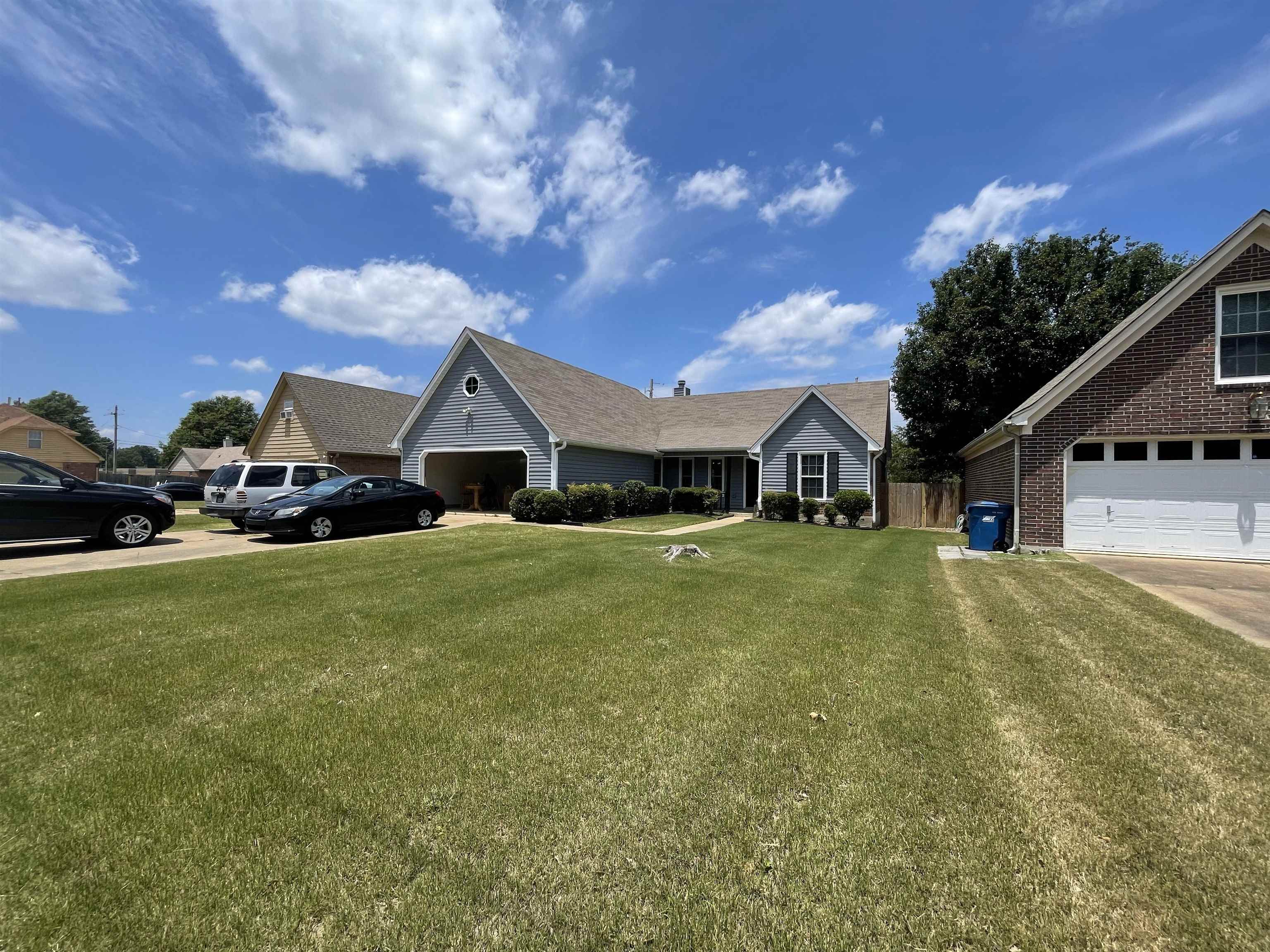 7800 Lowrance Road Memphis, TN 38125 - Photo 2 of 3 a front view of house with yard and trees in the background
