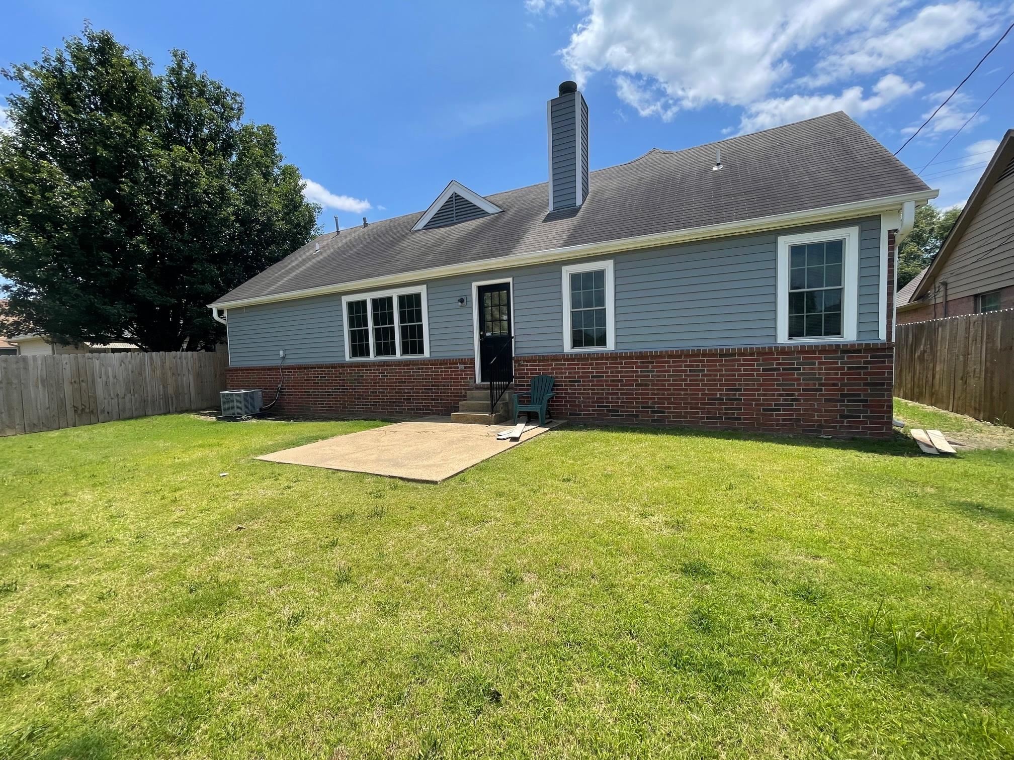 7800 Lowrance Road Memphis, TN 38125 - Photo 3 of 3 a front view of house with yard and trees in the background
