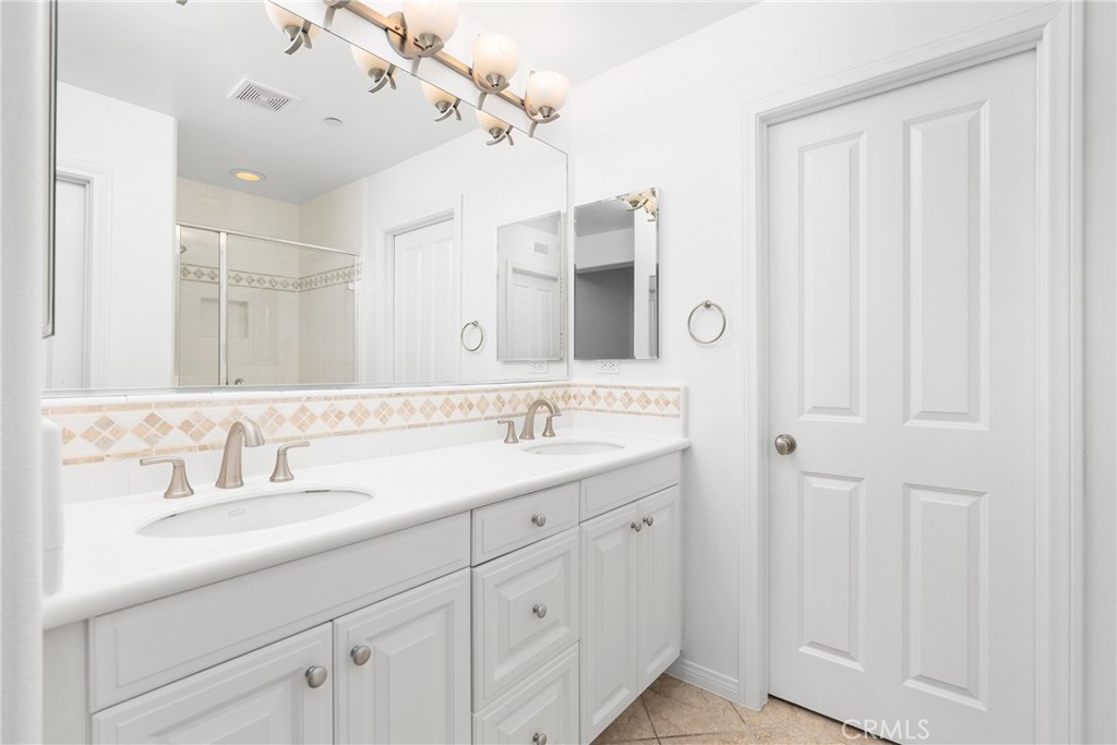 74 Clouds Irvine, CA 92603 - Photo 11 of 27 a bathroom with a double vanity sink and a mirror