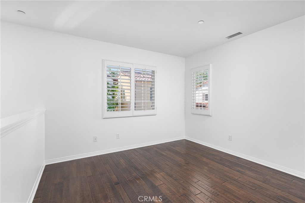 74 Clouds Irvine, CA 92603 - Photo 12 of 27 an empty room with wooden floor and windows