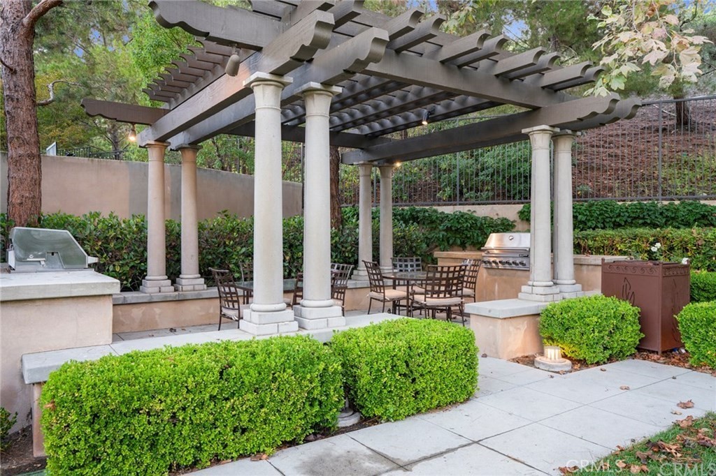 74 Clouds Irvine, CA 92603 - Photo 24 of 27 a front view of a house with garden and porch