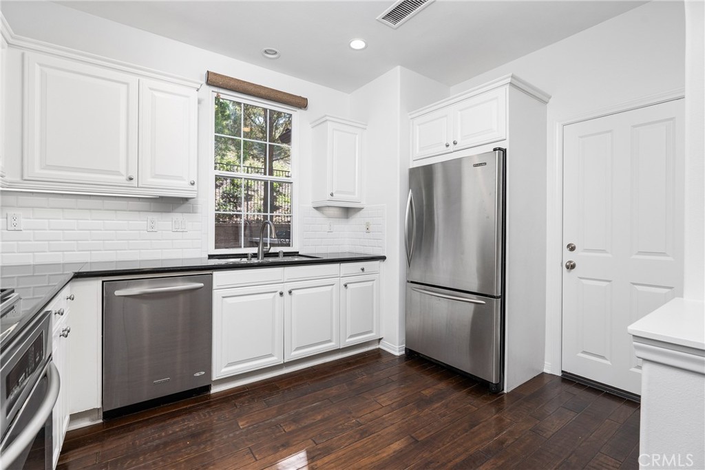 74 Clouds Irvine, CA 92603 - Photo 4 of 27 a kitchen with a refrigerator and a sink