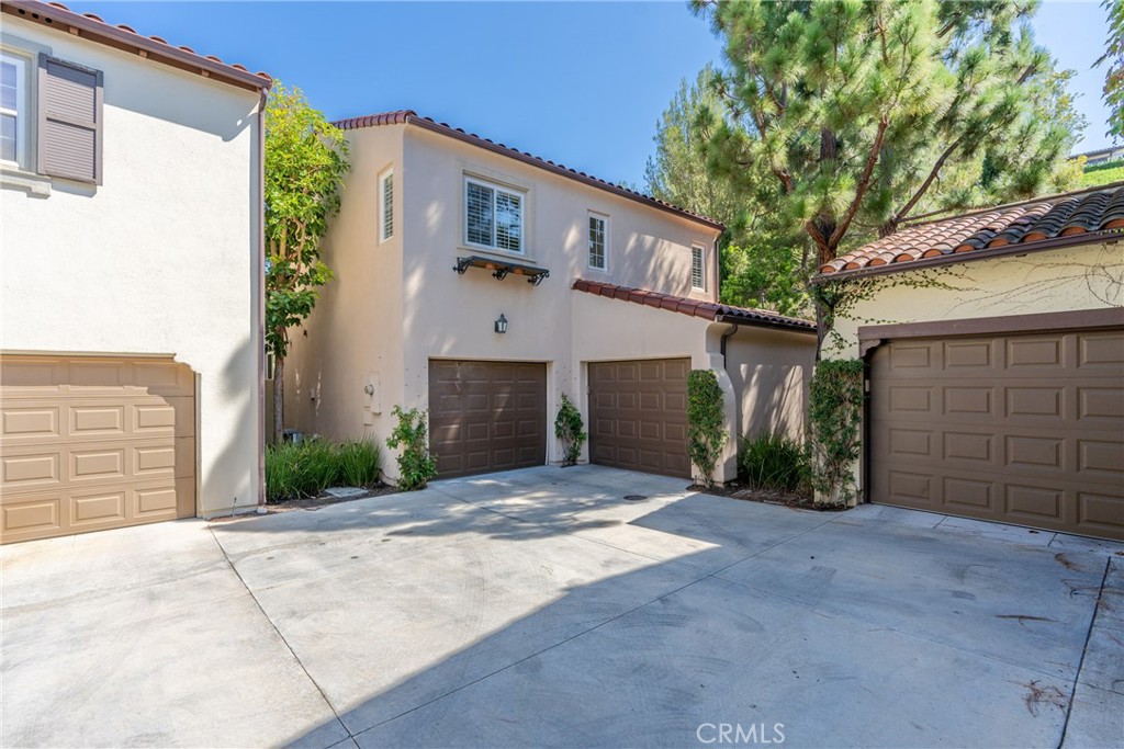 74 Clouds Irvine, CA 92603 - Photo 6 of 27 a view of a house with a garage