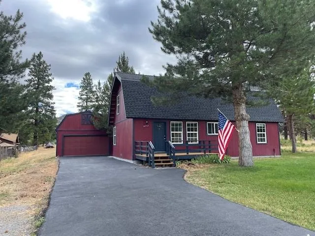 a sign board with a yard and fence