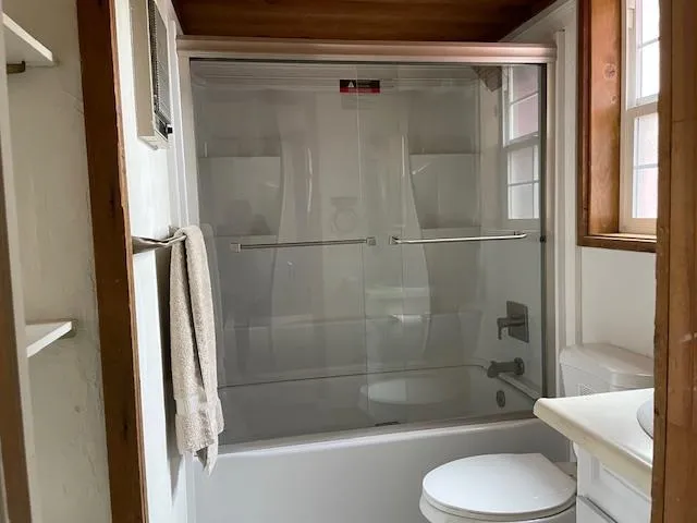 a spacious bedroom with a bed and a chandelier