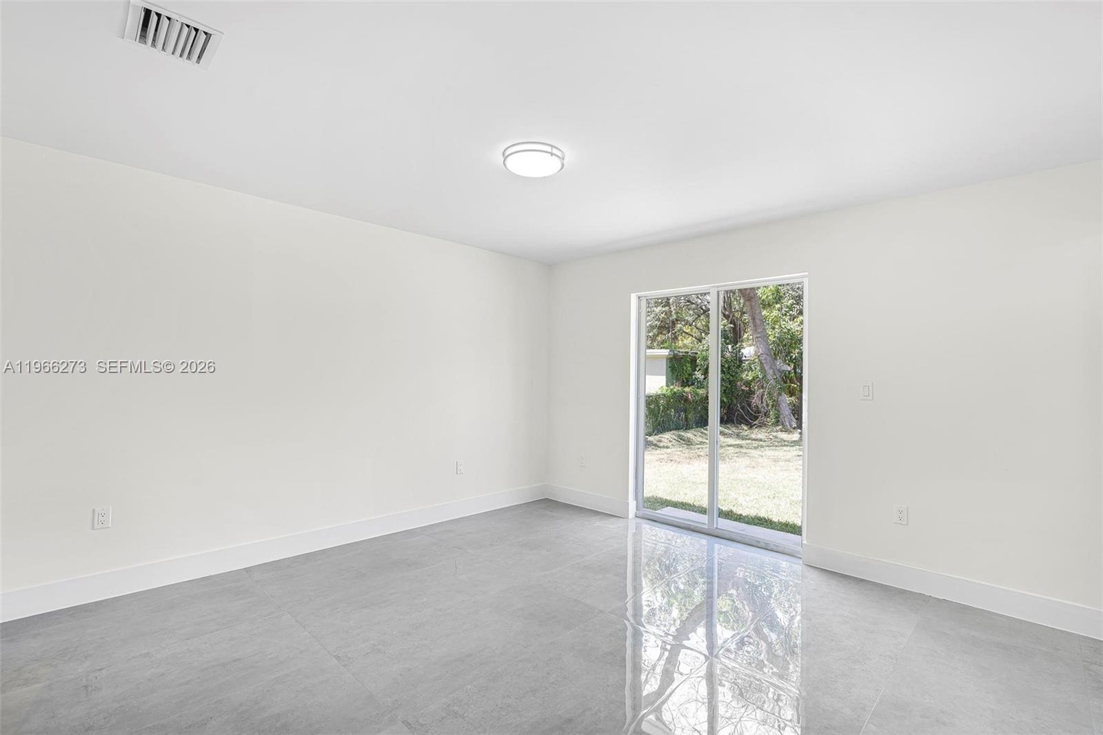 933 Northwest 50th Street Miami, FL 33127 - Photo 12 of 31 an empty room with windows